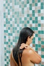 Beautiful Young woman washing hair with  shampo in the shower. Hair care. Royalty Free Stock Photo