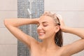 Beautiful young woman washing hair in shower Royalty Free Stock Photo