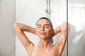 Beautiful young woman washing hair in shower at home Royalty Free Stock Photo