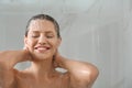 Beautiful young woman washing hair in shower at home. Space for text Royalty Free Stock Photo