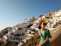 Beautiful young woman watching colorful orange sunset in Oia, Santorini, Greece Royalty Free Stock Photo