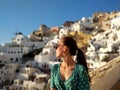 Beautiful young woman watching colorful orange sunset in Oia, Santorini, Greece Royalty Free Stock Photo