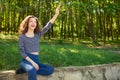 Beautiful young woman waves hand to somebody