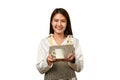 Beautiful young woman wearing apron holding coffee cup isolated over white background. Small business startup concept Royalty Free Stock Photo