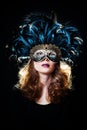 Beautiful young woman wearing carnival mask with feathers Royalty Free Stock Photo