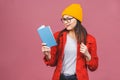 Beautiful young woman wearing casual standing isolated over pink background, reading a book Royalty Free Stock Photo