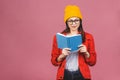 Beautiful young woman wearing casual standing isolated over pink background, reading a book Royalty Free Stock Photo