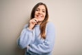 Beautiful young woman wearing casual winter sweater standing over isolated background looking confident at the camera with smile Royalty Free Stock Photo