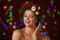 Beautiful young woman wearing Christmas wreath on blurred background Royalty Free Stock Photo