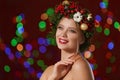 Beautiful young woman wearing Christmas wreath on blurred background Royalty Free Stock Photo