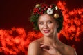 Beautiful young woman wearing Christmas wreath on blurred background Royalty Free Stock Photo