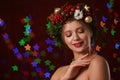 Beautiful young woman wearing Christmas wreath on blurred background Royalty Free Stock Photo