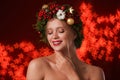 Beautiful young woman wearing Christmas wreath on blurred background Royalty Free Stock Photo