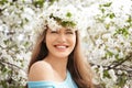 Beautiful young woman wearing flower wreath outdoors on spring day Royalty Free Stock Photo