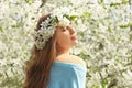 Beautiful young woman wearing flower wreath outdoors on spring day Royalty Free Stock Photo