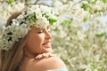 Beautiful young woman wearing flower wreath outdoors on spring day Royalty Free Stock Photo