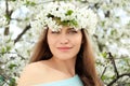 Beautiful young woman wearing flower wreath outdoors on spring day Royalty Free Stock Photo