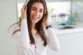 Beautiful young woman wearing headphones listening to music, enjoying and dancing happy Royalty Free Stock Photo