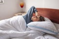 Woman stretching and yawning in bed while waking up Royalty Free Stock Photo