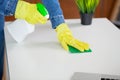 Beautiful young woman wearing protective gloves cleaning the desk in office Royalty Free Stock Photo