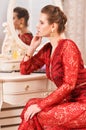 Close up portrait of young woman sitting at dressing table Royalty Free Stock Photo