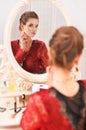 Portrait of young woman sitting at dressing table Royalty Free Stock Photo