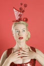 Beautiful young woman wearing red headgear over colored background