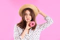 Beautiful young woman wearing stylish hat with donut on pink background Royalty Free Stock Photo