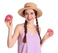 Beautiful young woman wearing stylish hat with donuts on white background Royalty Free Stock Photo