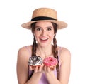 Beautiful young woman wearing stylish hat with donuts on white background Royalty Free Stock Photo