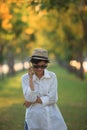 Beautiful young woman wearing sun glassea nd straw hat talking o