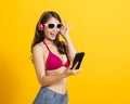 Beautiful young woman wearing swimsuit bikini and watching smart phone Royalty Free Stock Photo