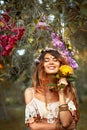 Beautiful young woman wearing wreath outdoors portrait with eyes closed Royalty Free Stock Photo