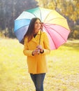 Beautiful young woman wearing a yellow coat with umbrella Royalty Free Stock Photo
