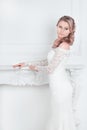 Beautiful young woman in wedding dress standing in Bridal salon . Royalty Free Stock Photo