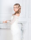 Beautiful young woman in wedding dress standing in Bridal salon . Royalty Free Stock Photo