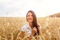 Beautiful young woman in wheat field. Cute brunette girl Royalty Free Stock Photo