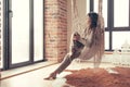 Woman wearing cashmere nightwear relaxing in cabin near fireplace