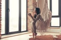 Woman wearing cashmere nightwear relaxing in cabin near fireplace Royalty Free Stock Photo