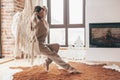 Woman wearing cashmere nightwear relaxing in cabin near fireplace Royalty Free Stock Photo