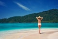 Beautiful young woman in white bikini enjoy her summer vacation on tropical beach in paradise island Royalty Free Stock Photo