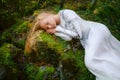 Beautiful young woman in a white dress in the middle of a forest Royalty Free Stock Photo