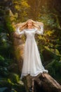 Beautiful young woman in a white dress in the middle of a forest Royalty Free Stock Photo