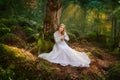 Beautiful young woman in a white dress in the middle of a forest Royalty Free Stock Photo