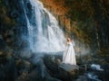 Beautiful young woman in a white dress in the middle of a forest Royalty Free Stock Photo