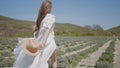 Beautiful young woman in white dress runs across field. Action. Woman's hair and dress flutter beautifully while running Royalty Free Stock Photo