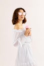 beautiful young woman in white dress with vanilla ice cream in a waffle cone. soft light. space for text Royalty Free Stock Photo