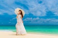 Beautiful young woman in white dress with umbrella on a tropical beach Royalty Free Stock Photo