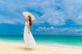 Beautiful young woman in white dress with umbrella on a tropical beach Royalty Free Stock Photo