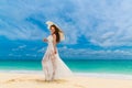 Beautiful young woman in white dress with umbrella on a tropical Royalty Free Stock Photo